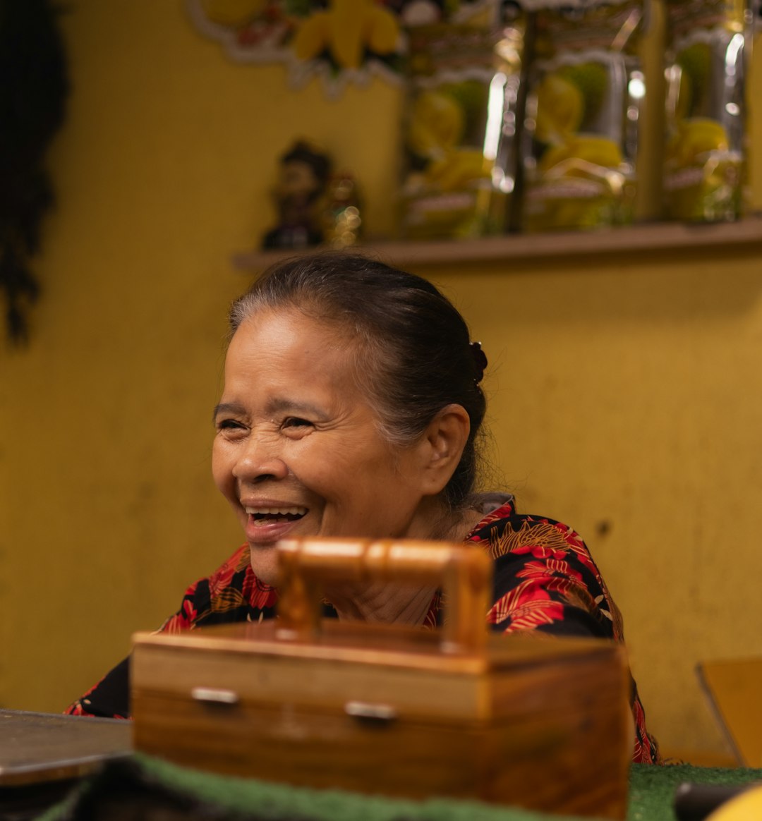 A woman sitting at a table with a suitcase